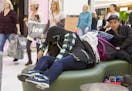 Sue Yuan, left, takes a nap as she and fellow University of Minnesota student Michael Zhang wait for their friends at the Mall of America in Bloomingt