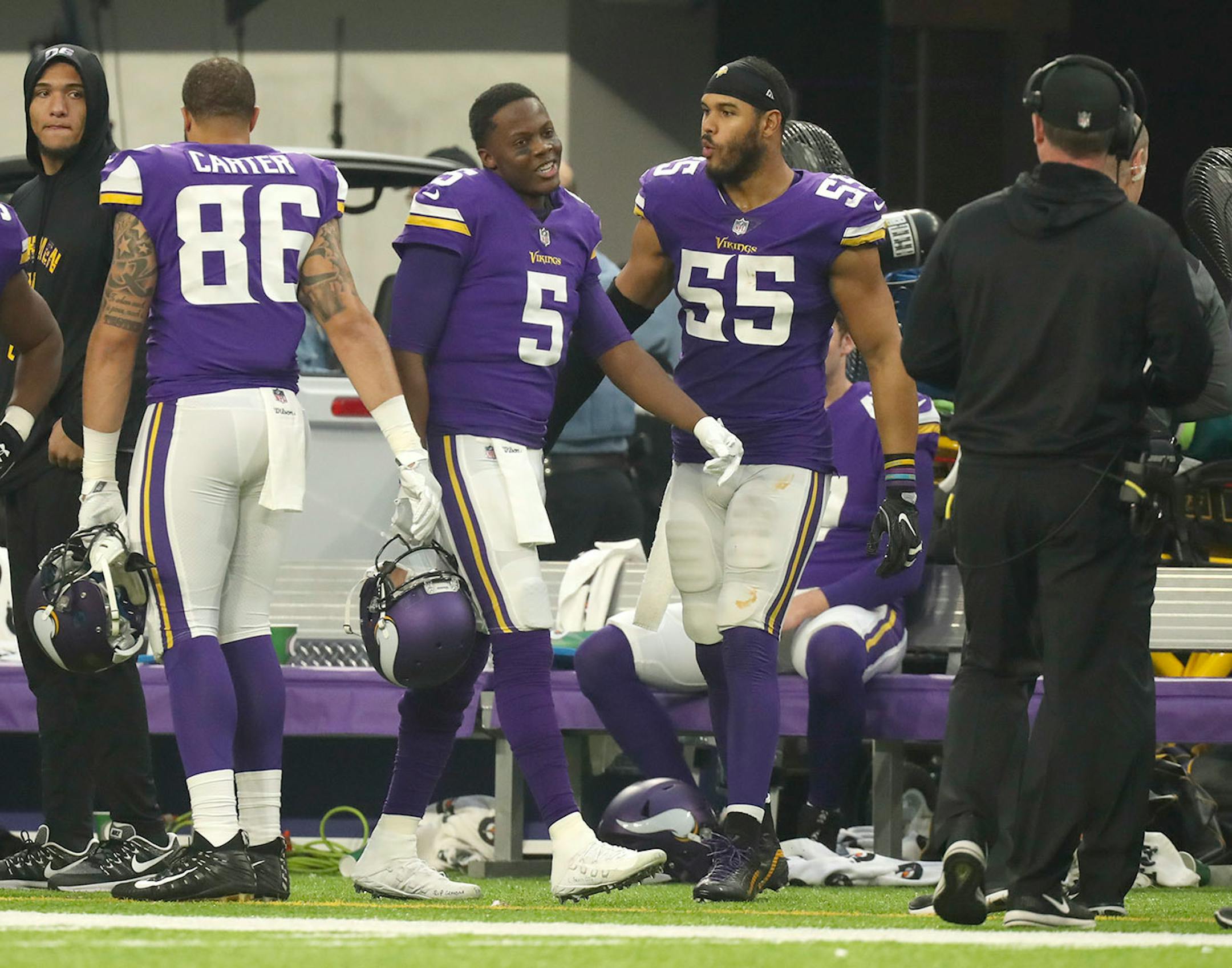 Vikings quarterback Teddy Bridgewater (5) smiled at Vikings head coach Mike Zimmer, right, as he returned to the Vikings bench after playing a fourth quarter series that ended with him throwing an interception on his first pass attempt.