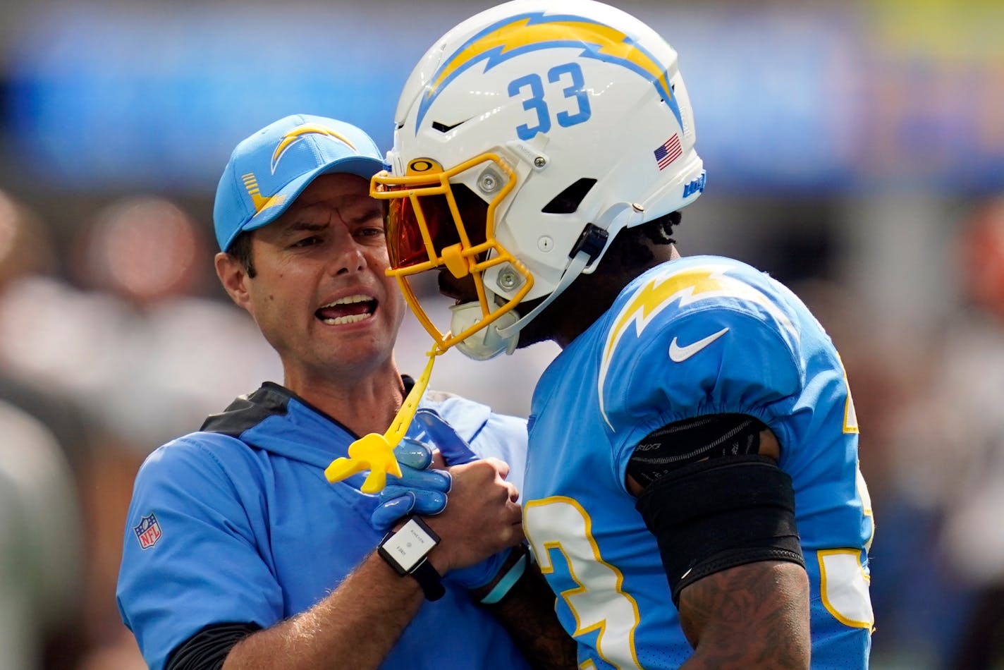 Los Angeles Chargers head coach Brandon Staley talks to free safety Derwin James (33) before an NFL football game against the Cleveland Browns Sunday, Oct. 10, 2021, in Inglewood, Calif. (AP Photo/Gregory Bull)