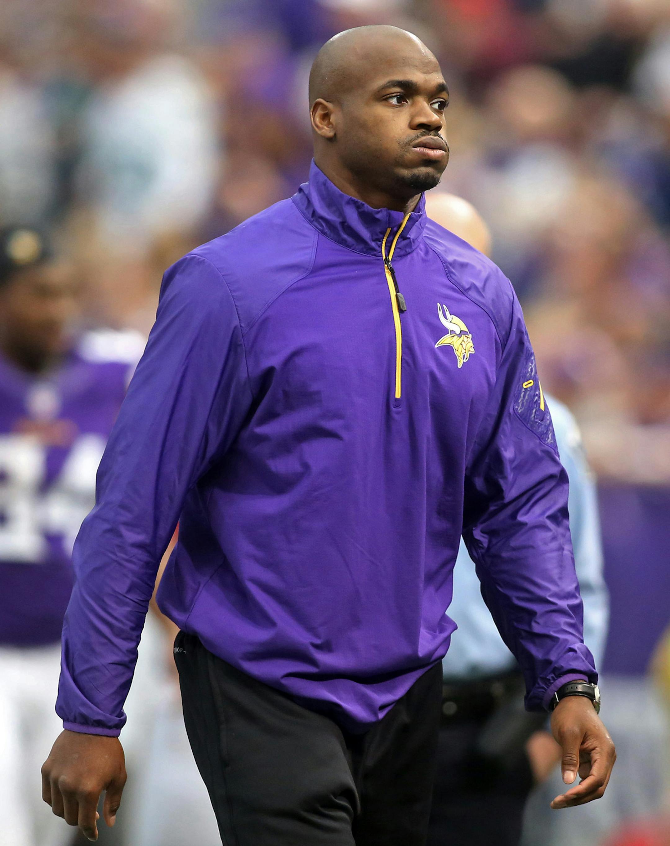 Adrian Peterson walked off the field at the end of the half against the Philadelphia Eagles. He was unable to play because of an ankle injury.