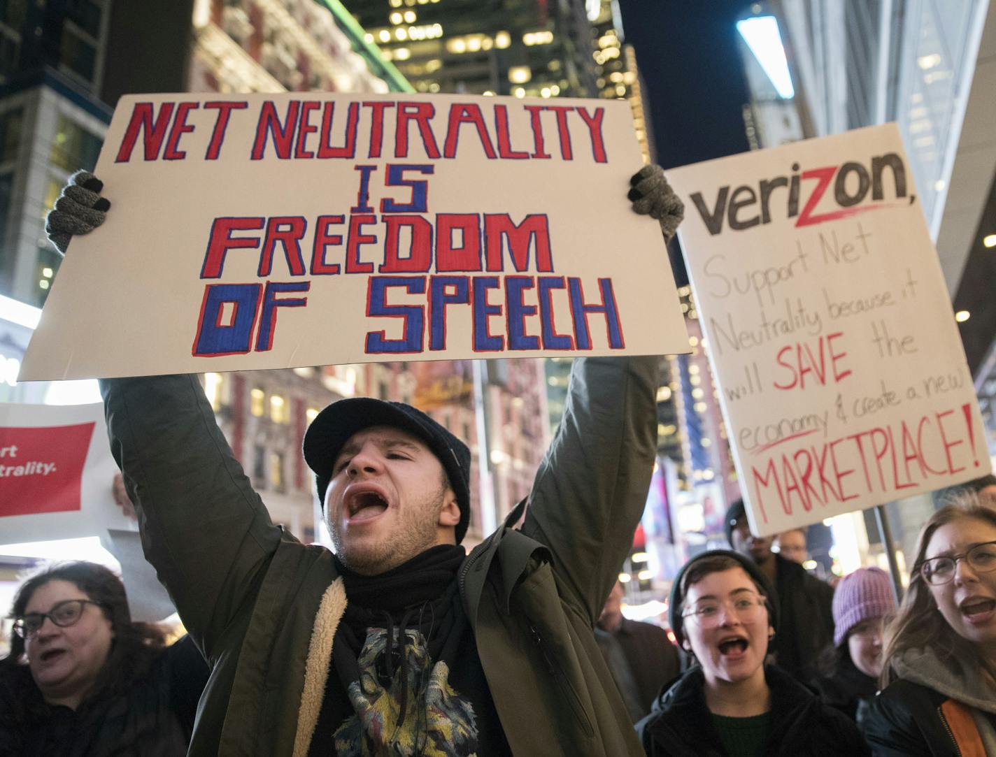 Demonstrators rally in support of net neutrality outside a Verizon store, Thursday, Dec. 7, 2017, in New York. The FCC is set to vote Dec. 14 whether to scrap Obama-era rules around open internet access that prevent phone and cable companies from favoring certain websites and apps. (AP Photo/Mary Altaffer)