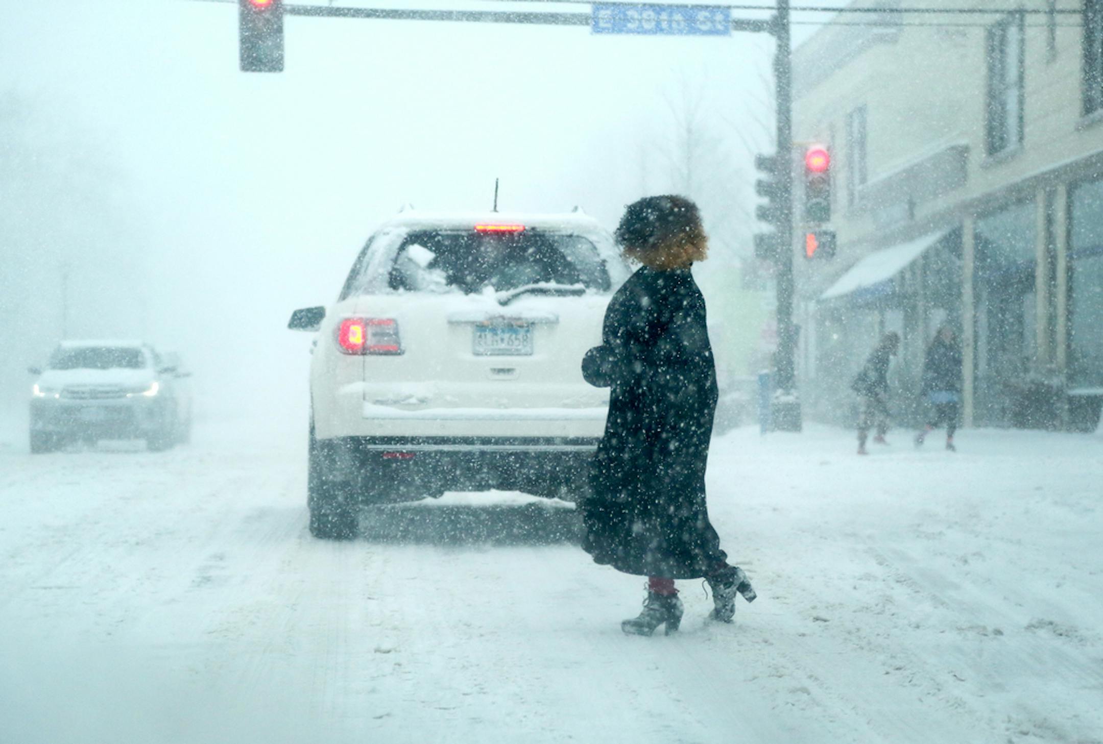 A woman crossed Nicollet Avenue at 38th St. during the blizzard of April 2018. Whiteout blizzard conditions are possible across much of southern Minnesota on Saturday night, the National Weather Service said.