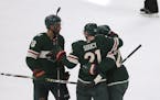 Minnesota Wild's Carson Soucy celebrates with teammates Jordan Greenway, left, and Jonas Brodin, right, after Soucy scored a short-handed goal against