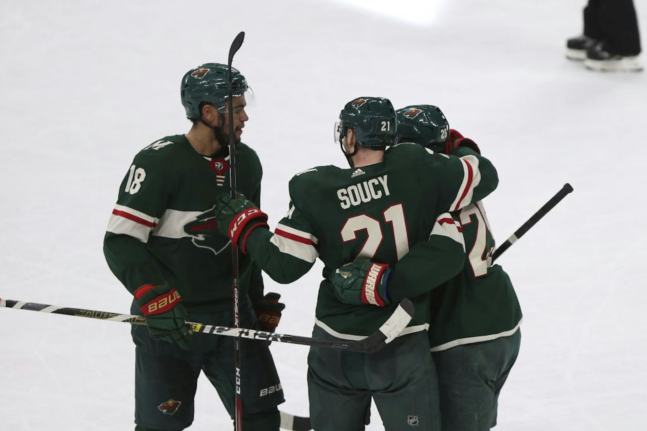 Minnesota Wild's Carson Soucy celebrates with teammates Jordan Greenway, left, and Jonas Brodin, right, after Soucy scored a short-handed goal against the Philadelphia Flyers in the third period of an NHL hockey game Saturday Dec. 14, 2019, in St. Paul, Minn. Minnesota won 4-1.