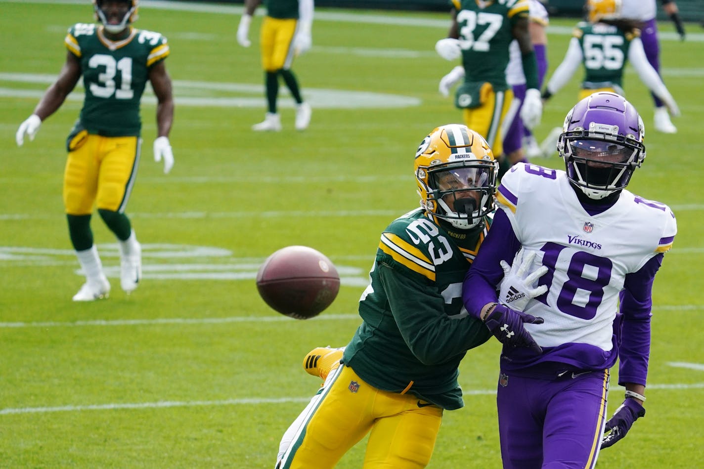 Minnesota Vikings wide receiver Justin Jefferson (18) was unable to complete a touchdown pass as Green Bay Packers cornerback Jaire Alexander (23) defended in the third quarter.