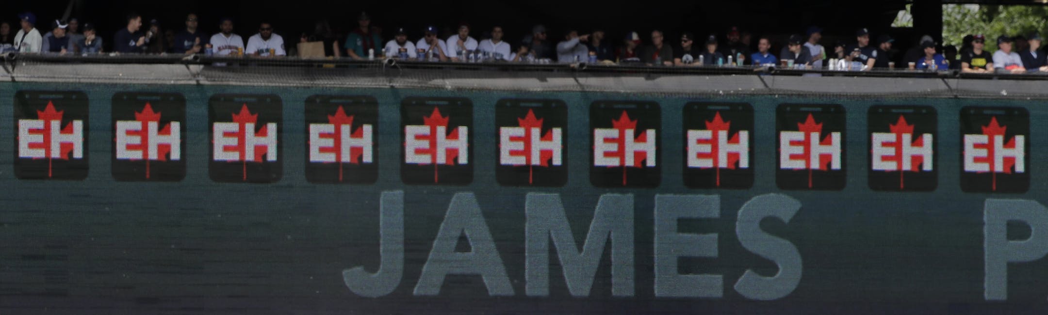 With a video display illustrating his 11 strikeouts, Seattle Mariners starting pitcher James Paxton, right, walks back to the mound during the eighth inning of a baseball game against the Kansas City Royals, Sunday, July 1, 2018, in Seattle. (AP Photo/Ted S. Warren)