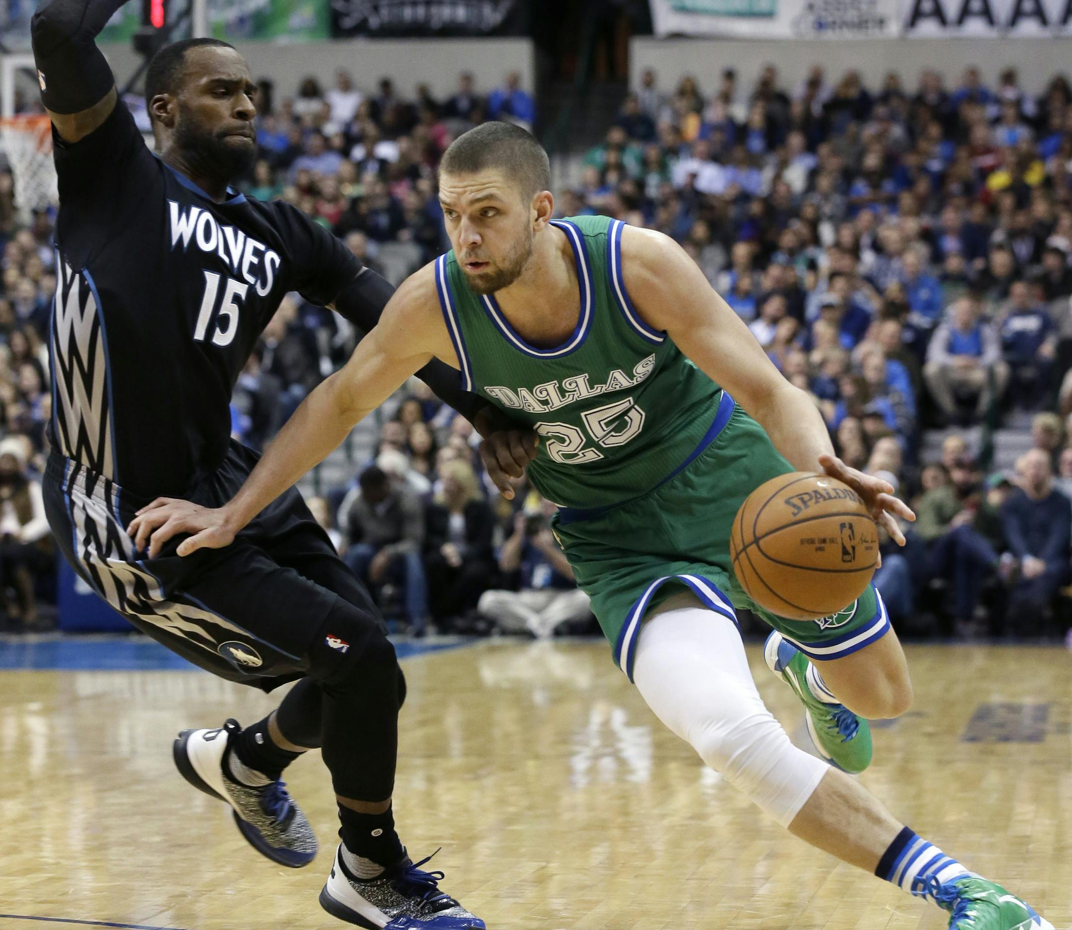 Dallas Mavericks forward Chandler Parsons (25) drives against Minnesota Timberwolves forward Shabazz Muhammad (15) during the second half of an NBA basketball game Wednesday, Jan. 20, 2016, in Dallas. The Mavericks won 106-94 in overtime. (AP Photo/LM Otero)