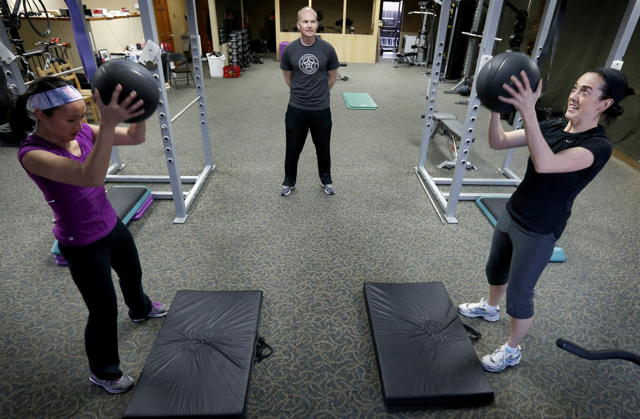Jon Fagerness owner and trainer at Fitness Pros in Blaine watched Veronica Basel, 29, and Maggie Tatton, 34 during a workout. The two are training for a triathlon. ] CARLOS GONZALEZ cgonzalez@startribune.com April 03, 2013, Blaine, Minn., Fitness Pros, Blaine will be holding its second annual triathlon; a look at several of the participants as they train for the May event.