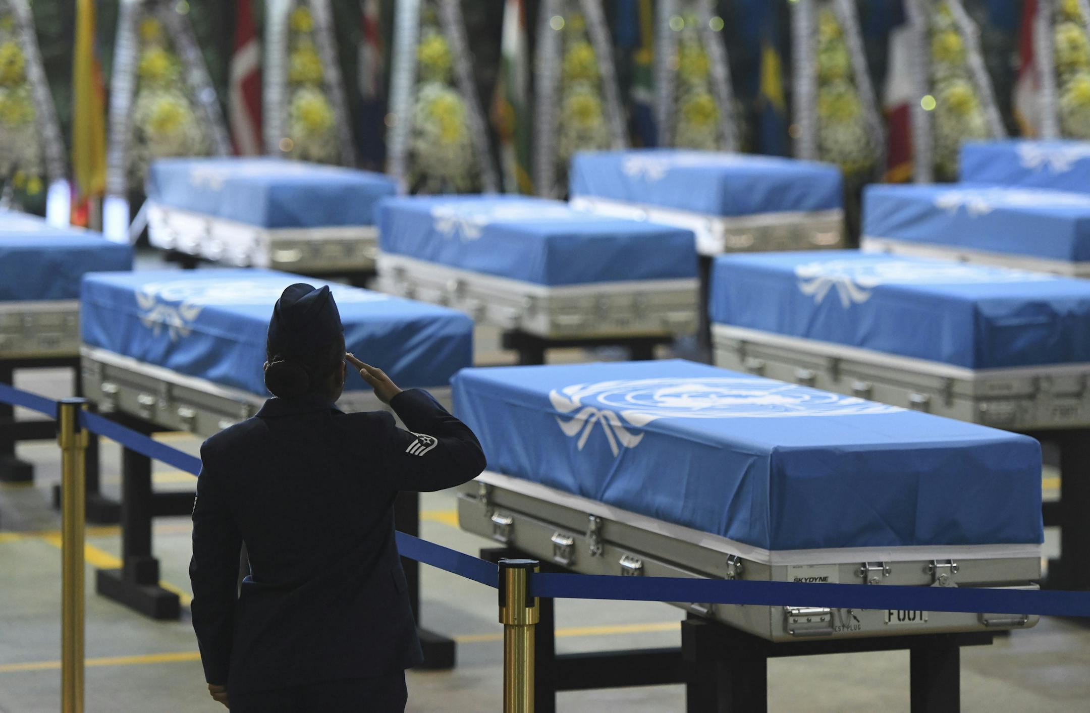 A U.S. soldier salutes during a repatriation ceremony for the remains of U.S. soldiers killed in the Korean War and collected in North Korea, at the Osan Air Base in Pyeongtaek, South Korea, Wednesday, Aug. 1, 2018. North Korea handed over 55 boxes of the remains last week as part of agreements reached during a historic June summit between its leader Kim Jong Un and U.S. President Donald Trump. (Jung Yeon-je/Pool Photo via AP)