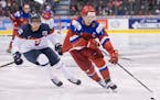 Russia's Kirill Kaprizov skates past Slovakia's Boris Sadecky during the third period of a world junior championship hockey game in Toronto on Saturda