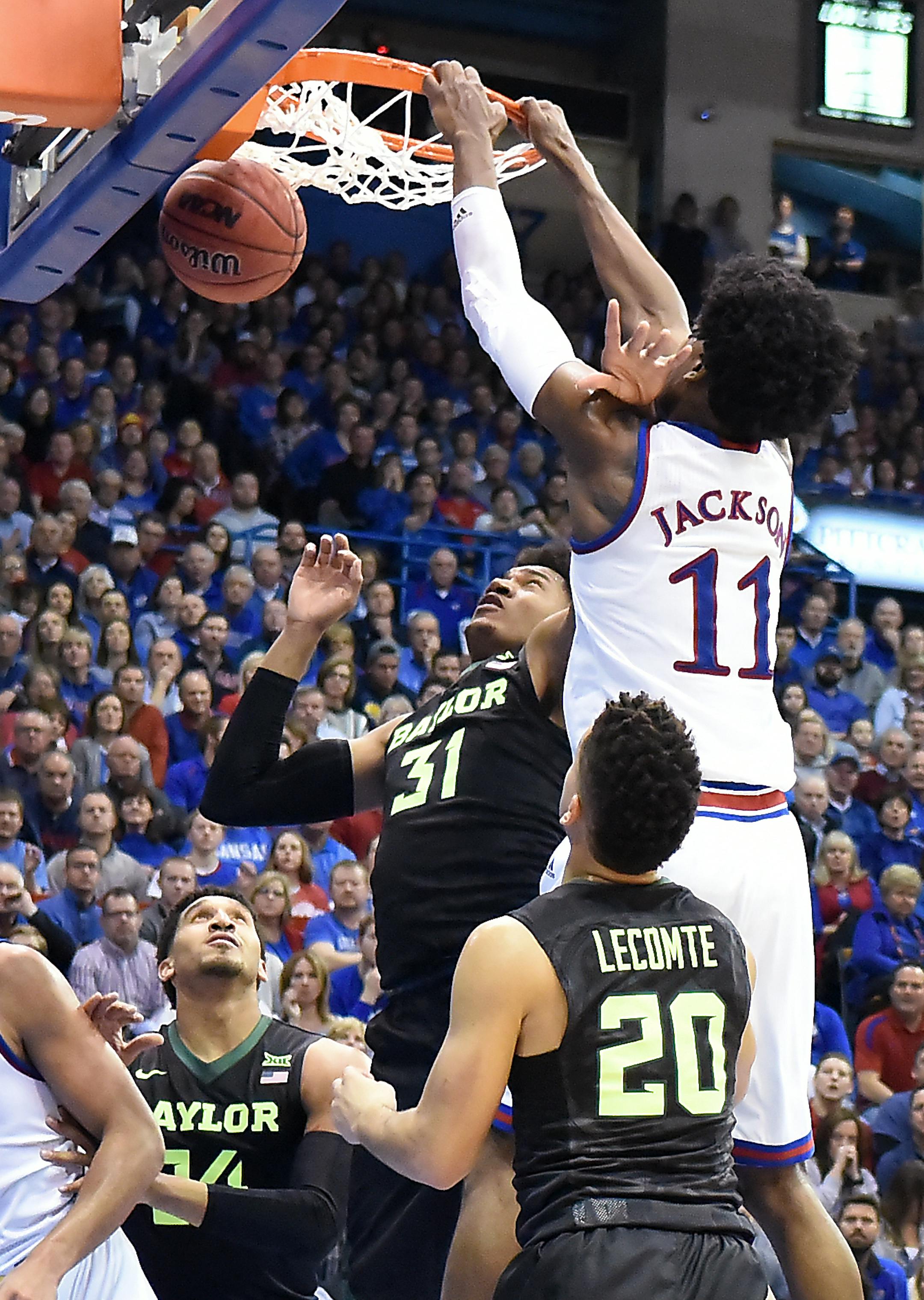 KU's Josh Jackson, who had a game-high 23 points, got two with a dunk over Baylor's Terry Maston (31) during the first half on Wednesday, Feb. 1, 2017, at Allen Fieldhouse in Lawrence, Kan. Kansas won, 73-68. (Rich Sugg/Kansas City Star/TNS)