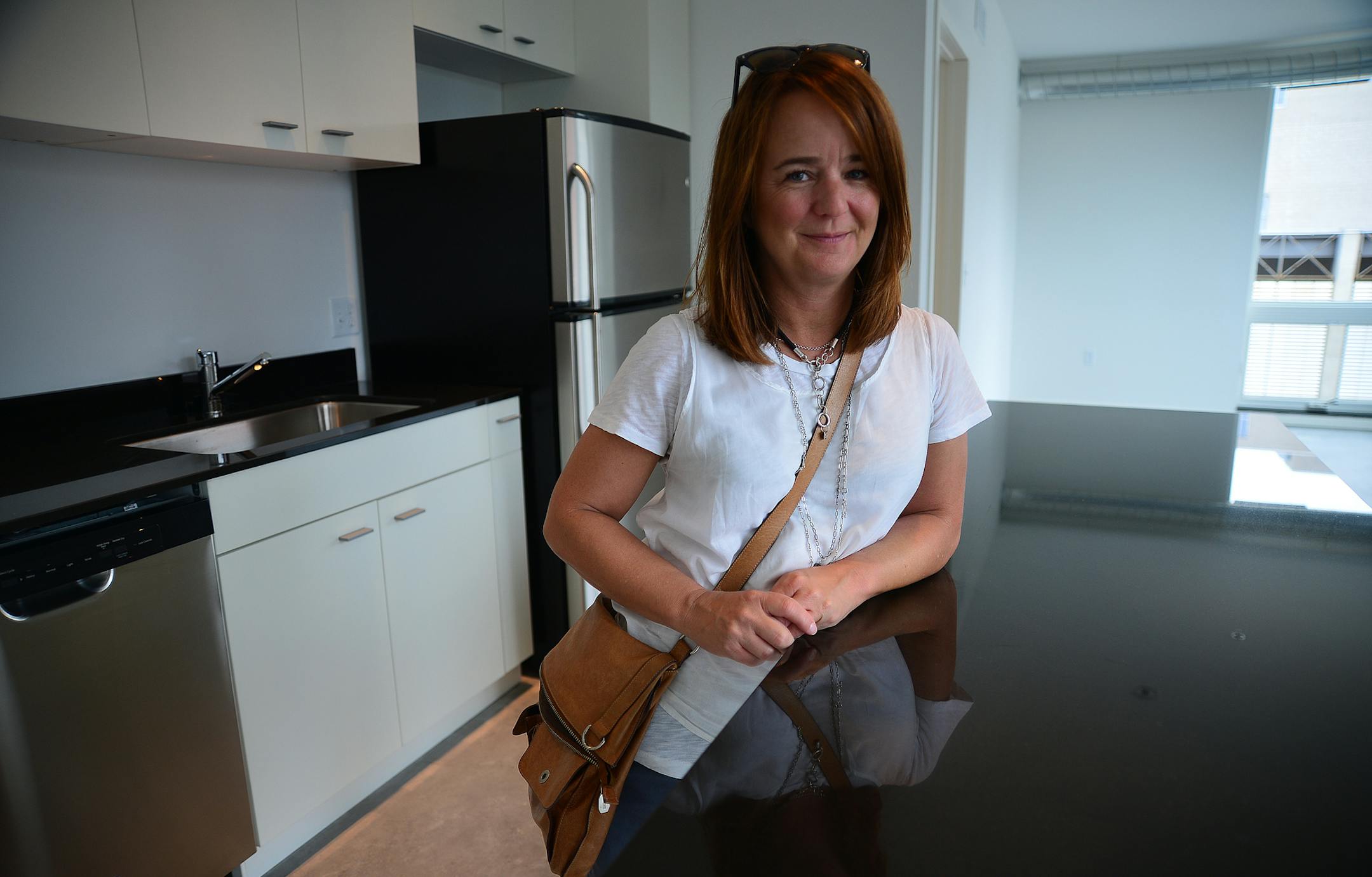 Brunsfield, an international development company headquartered in Malaysia, is making its U.S. debut with a boutique apartment building in Minneapolis at 915 Washington Avenue North. Jane Delworth did a walk through her apartment and will move in later Friday August 30, 2013 . ] Richard.Sennott@startribune.com Richard Sennott/Star Tribune Minneapolis Minnesota Thursday 8/230/13) ** (cq)