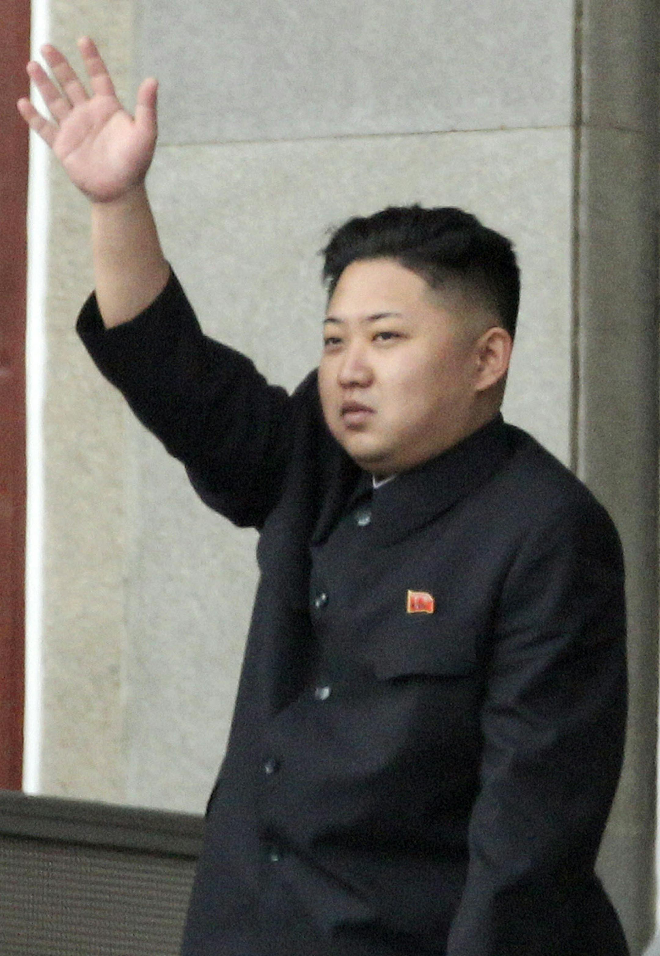 North Korean leader Kim Jong Un, right, waves as North Korean military officers clap during a mass meeting of North Korea's ruling party at a stadium in Pyongyang, North Korea on Saturday April 14, 2012. North Korea will mark the 100-year birth anniversary of the late leader Kim Il Sung on Sunday, April 15. (AP Photo/Ng Han Guan)