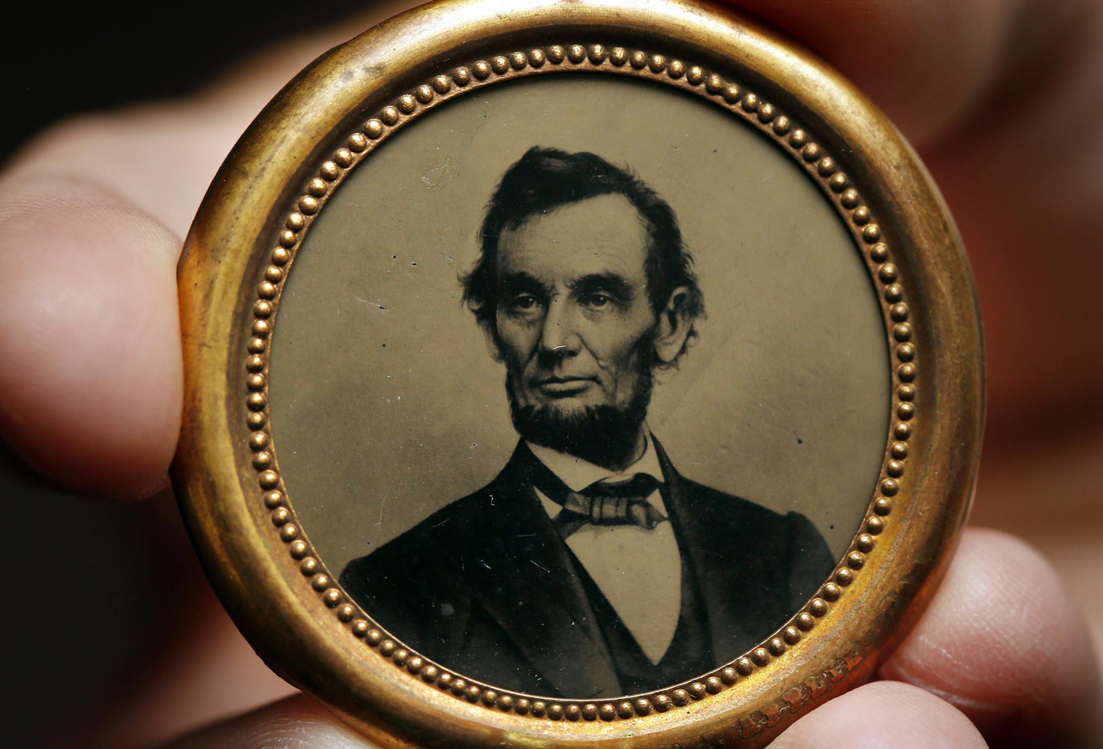 The ferrotype of Abraham Lincoln is shown ahead of an auction at the Pennsylvania Convention Center, Wednesday, Sept. 18, 2013, in Philadelphia. A highly prized collection of U.S. political memorabilia has gone up for auction. Among the items for sale are unusual ferrotypes of Abraham Lincoln. Those are essentially the forerunners of today's campaign buttons. Auction house Stack's Bowers Galleries is putting on the block more than 2,000 pieces from the John J. Ford Jr. Collection.(AP Photo/Matt