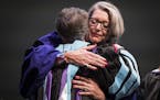 Rebecca Koenig Roloff, right, hugs Sister Jean Wincek, the vice chair of the St. Catherine Board of Trustees after she is inaugurated as president of 