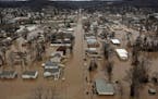 This photo shows a northern view of 1st Street where homes were flooded on Tuesday, Dec. 29, 2015, in Pacific, Mo. Torrential rains over the past seve