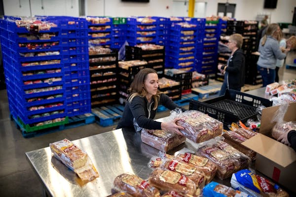 Kimberly Lawrence of Rosemount, a volunteer, packs loaves of bread at Second Harvest. Staff and volunteers at Second Harvest Heartland, the state's la
