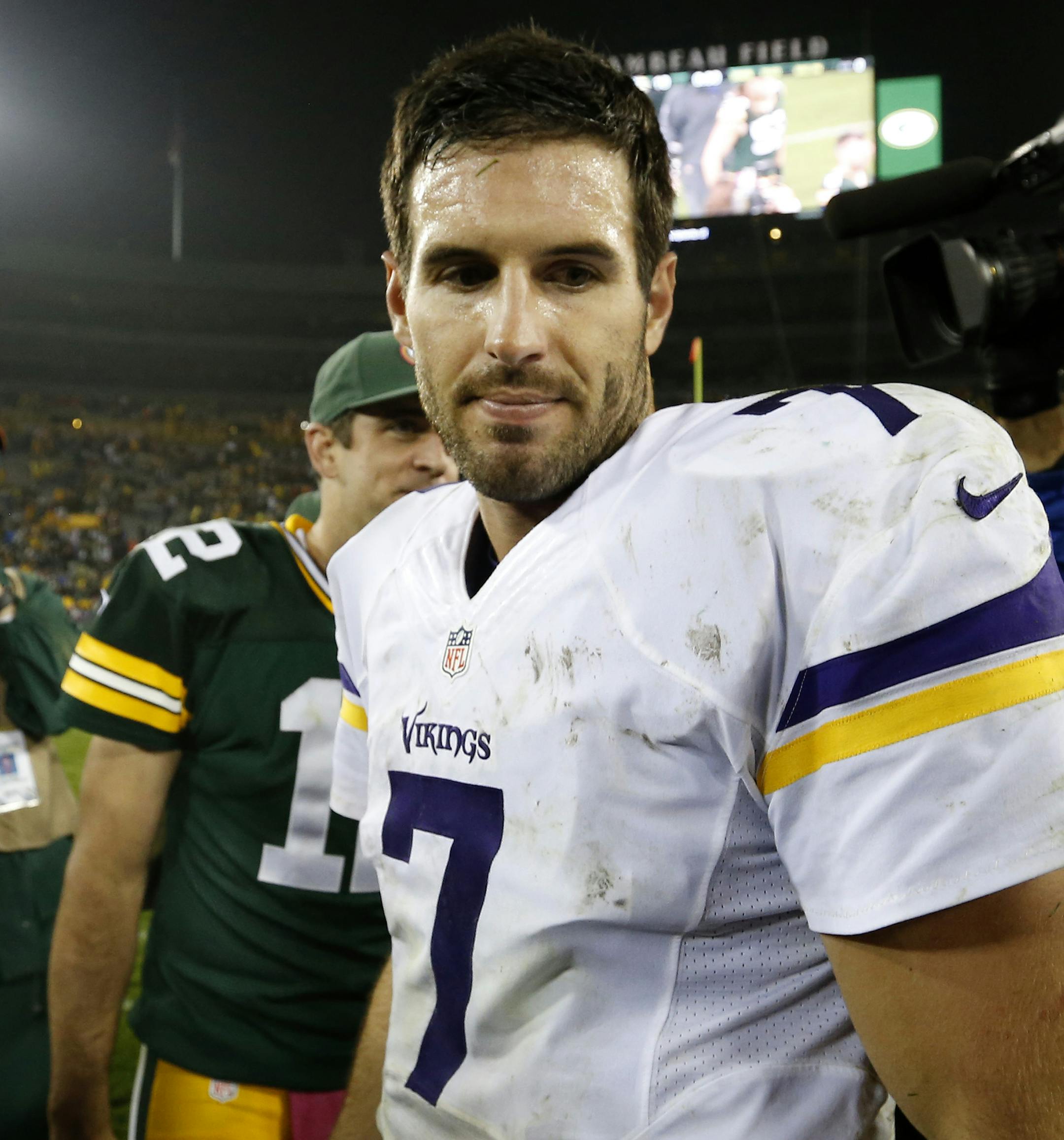Vikings quarterback Christian Ponder (7) walked away from Packers quarterback Aaron Rodgers (12) after shaking hands at the end of the game. Green Bay beat Minnesota by a final score of 42-10. ] CARLOS GONZALEZ cgonzalez@startribune.com - October 2, 2014 , Green Bay, WI NFL, Lambeau Field, Minnesota Vikings vs. Green bay Packers