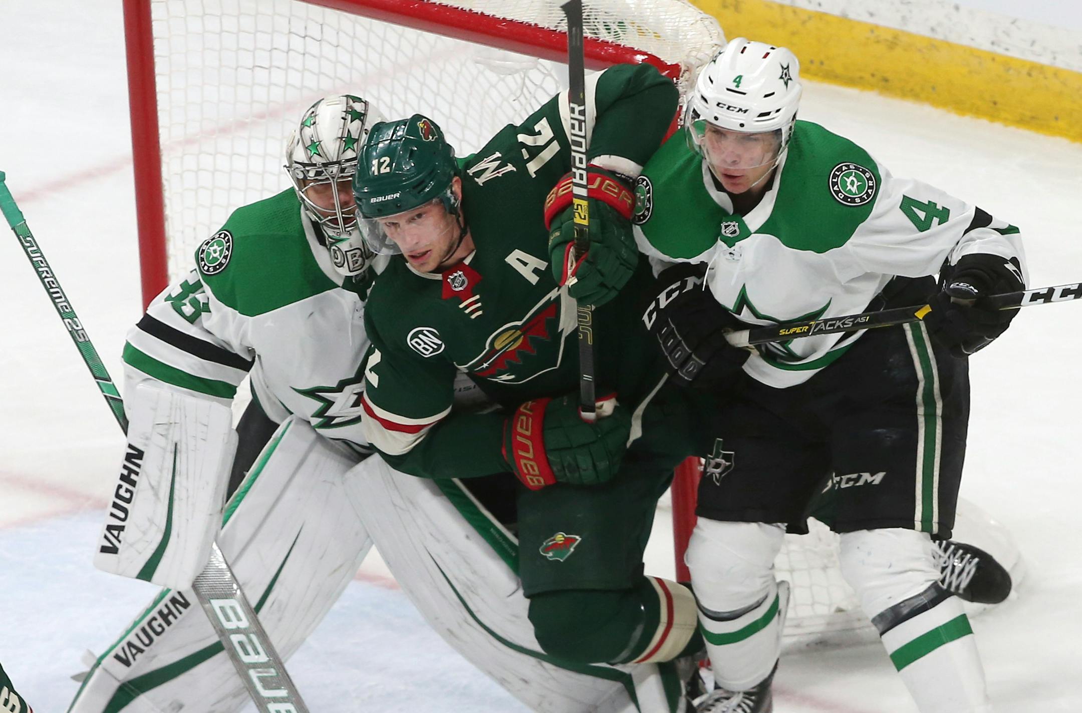 The Wild's Eric Staal, center, is squeezed between Stars goalie Anton Khudobin, left, and Miro Heiskanen