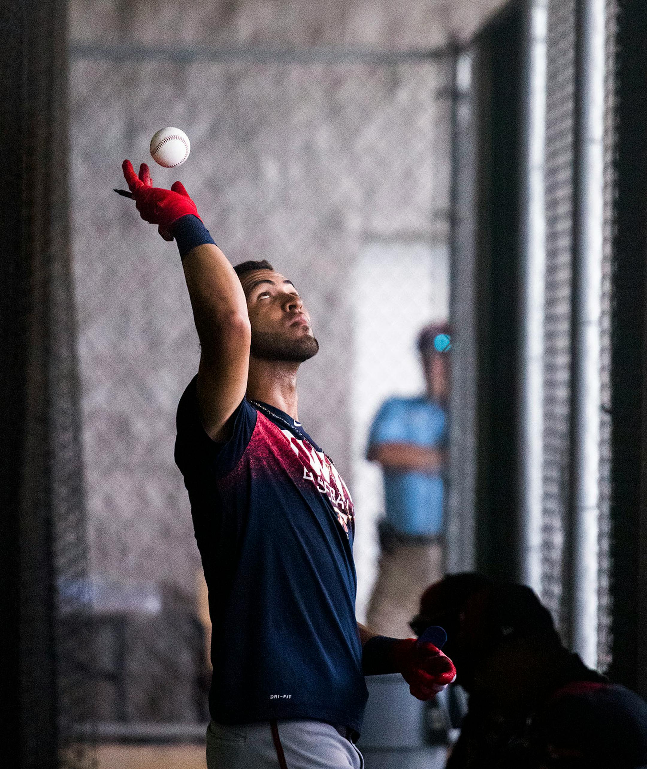 Twins outfielder Eddie Rosario (20) tossed signed balls over the batting cage fence to fans.