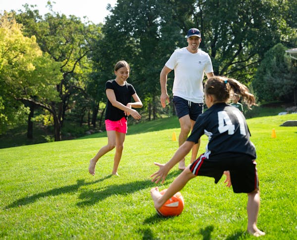 Wild goalie Marc-Andre Fleury played soccer with his daughters Estelle, 10, and Scarlett, 8, in the front yard of his Edina home on a sunny September 