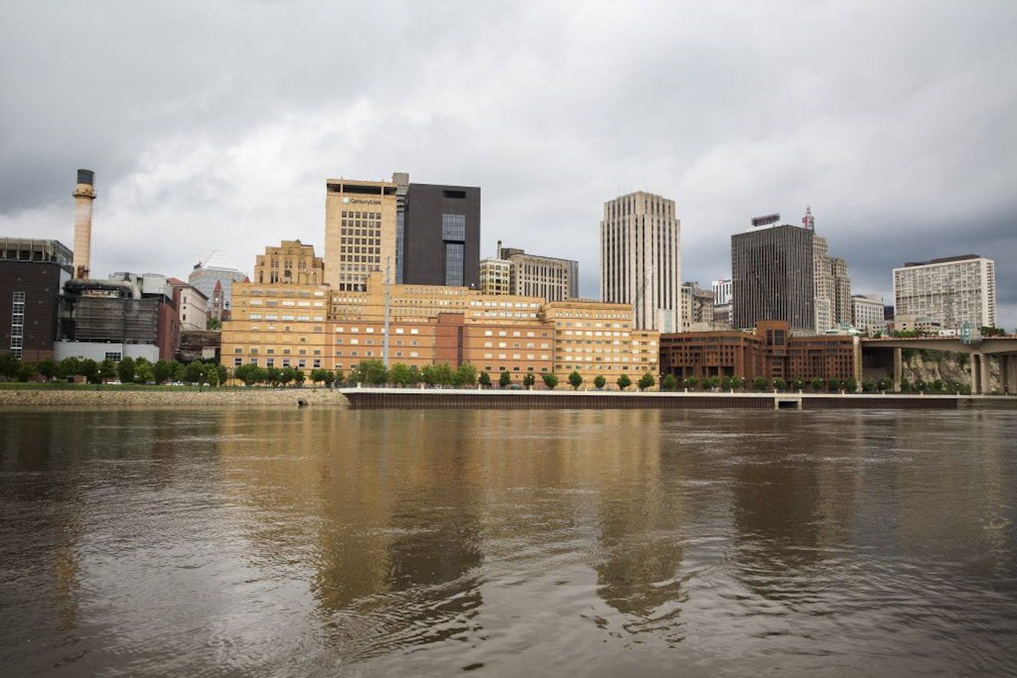 The former West Publishing building, long tan building on left, and former Ramsey County jail building, squat reddish-brown building on right, are seen from across the Mississippi River in downtown St. Paul on Friday, May 29, 2015.