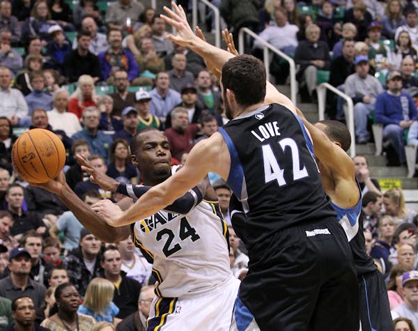 Utah Jazz forward Paul Millsap (24) attempts to pass off the ball as Minnesota Timberwolves forward Kevin Love (42) defends during the second half of 