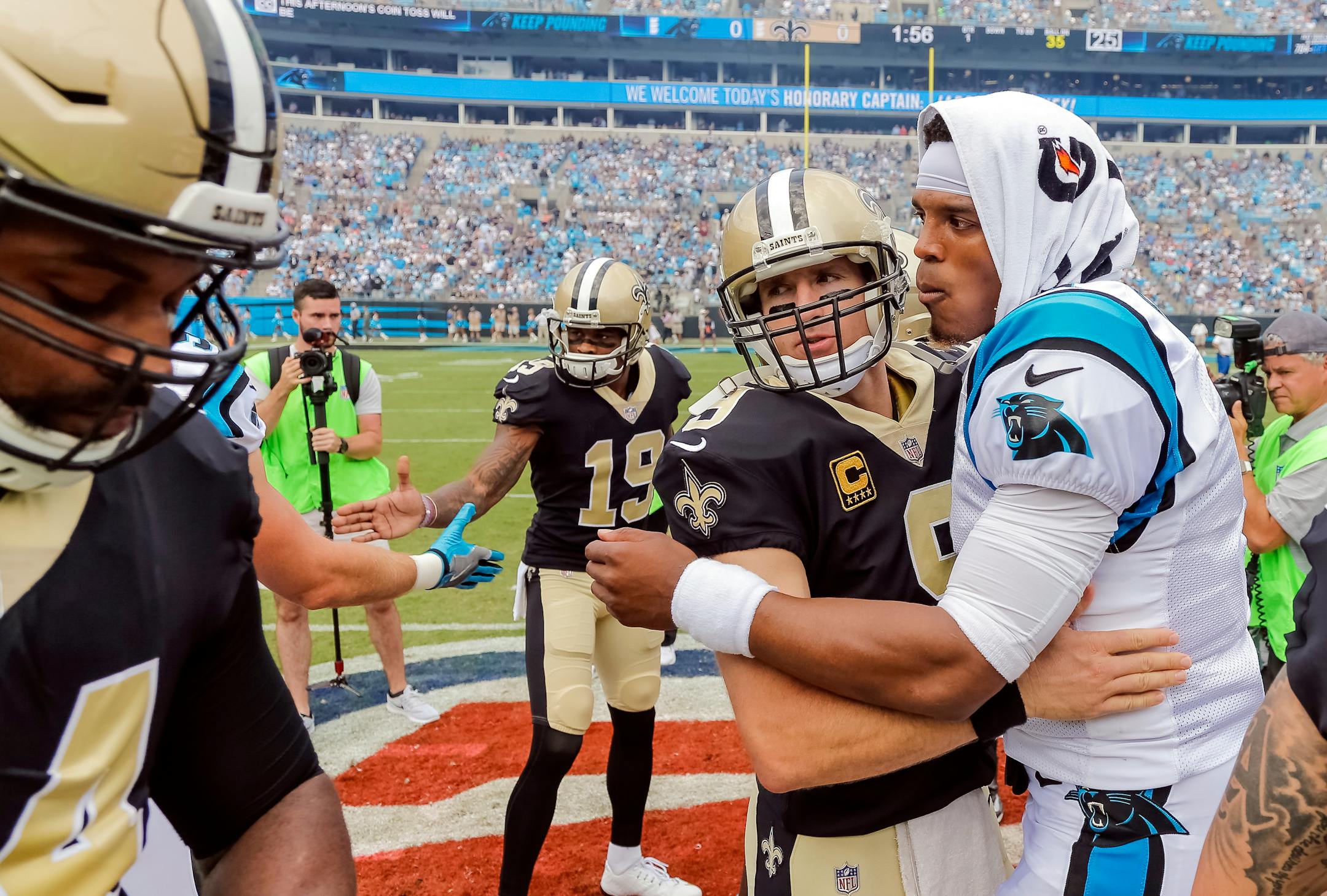 FILE - In this Sept. 24, 2017, file photo, Carolina Panthers' Cam Newton (1) and New Orleans Saints' Drew Brees (9) embrace before an NFL football game in Charlotte, N.C. Saints coach Sean Payton takes a small measure of comfort in New Orleans' regular-season sweep of Carolina. It means the Saints play the Panthers (11-5) in the Superdome, where New Orleans hasn�t lost a playoff game since 1992 and is 4-0 in the postseason under Payton. (AP Photo/Bob Leverone, File)