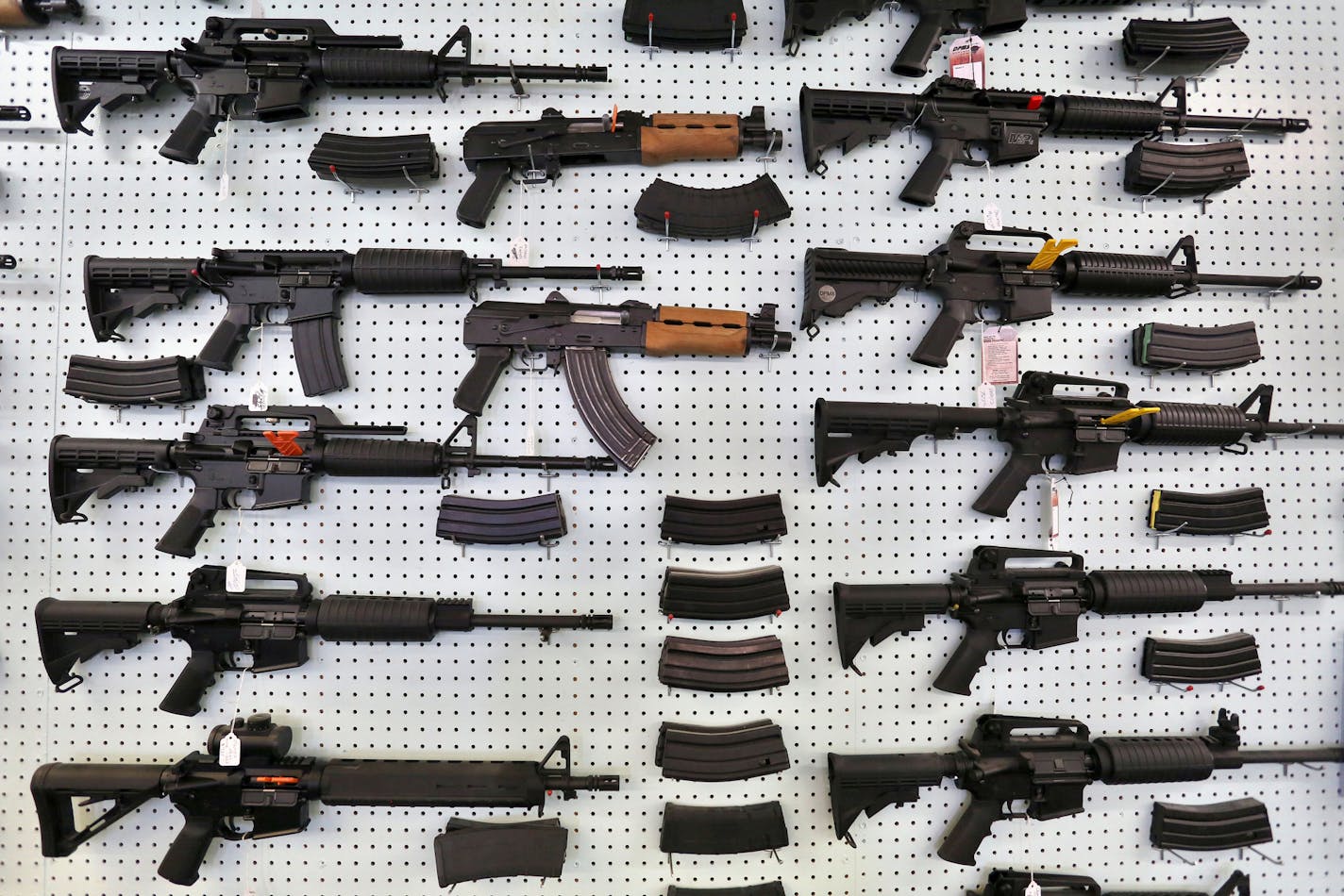 FILE - In this July 20, 2014 file photo, guns are displayed for sale by an arms seller east of Colorado Springs, Colo. The U.S. is among wealthy countries where suicides by gun outnumber gun killings, according to a study of 1990-2016 data, released on Tuesday, Aug. 28, 2018. (AP Photo/Brennan Linsley, File)