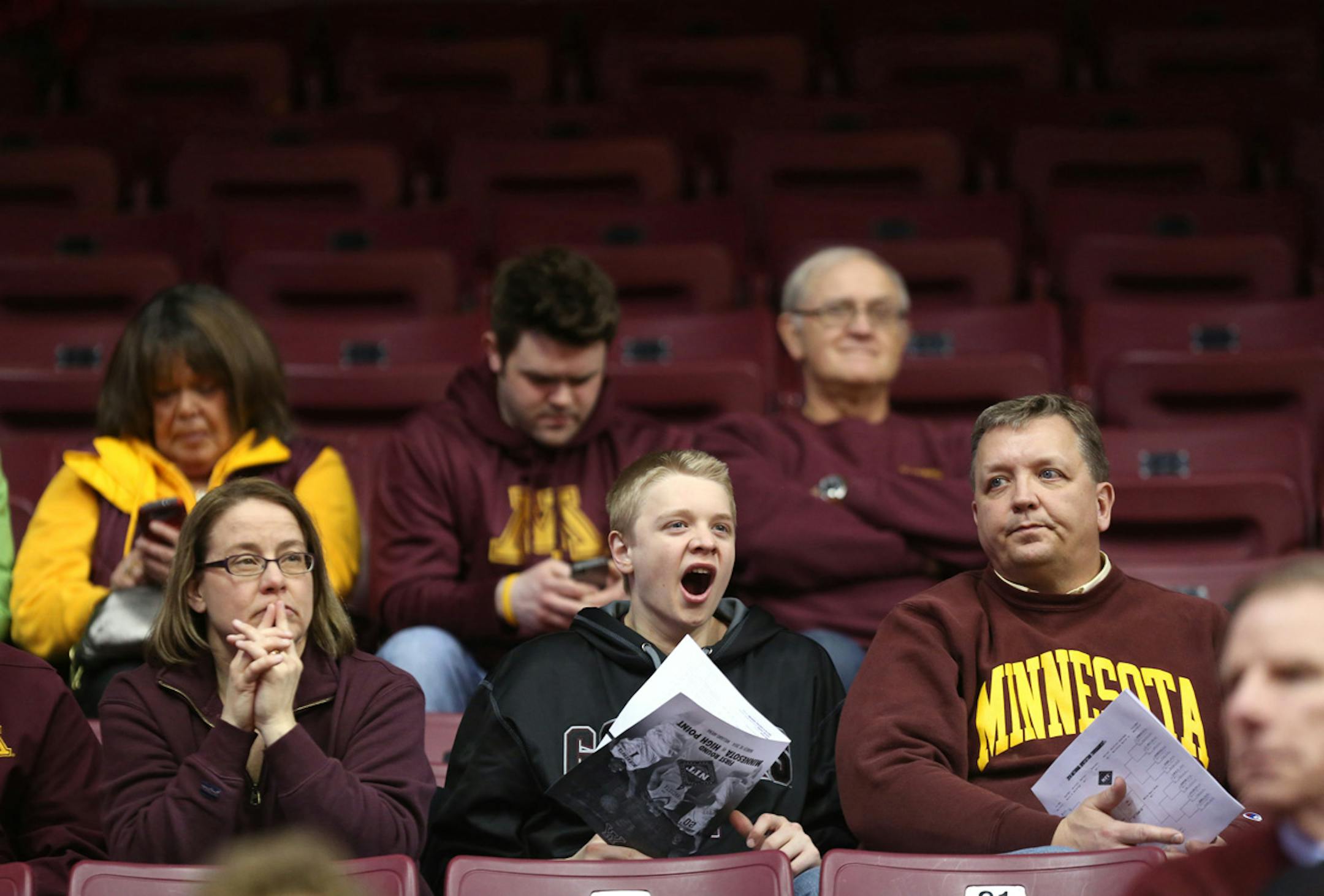 Gopher fan Will Farm, 15, of Rochester yawned a bit during a timeout on the floor in the first half against High Point. ] (KYNDELL HARKNESS/STAR TRIBUNE) kyndell.harkness@startribune.com First round of the National Invitational Tournament at Williams Arena in Minneapolis Min, Tuesday March 18, 2014.
