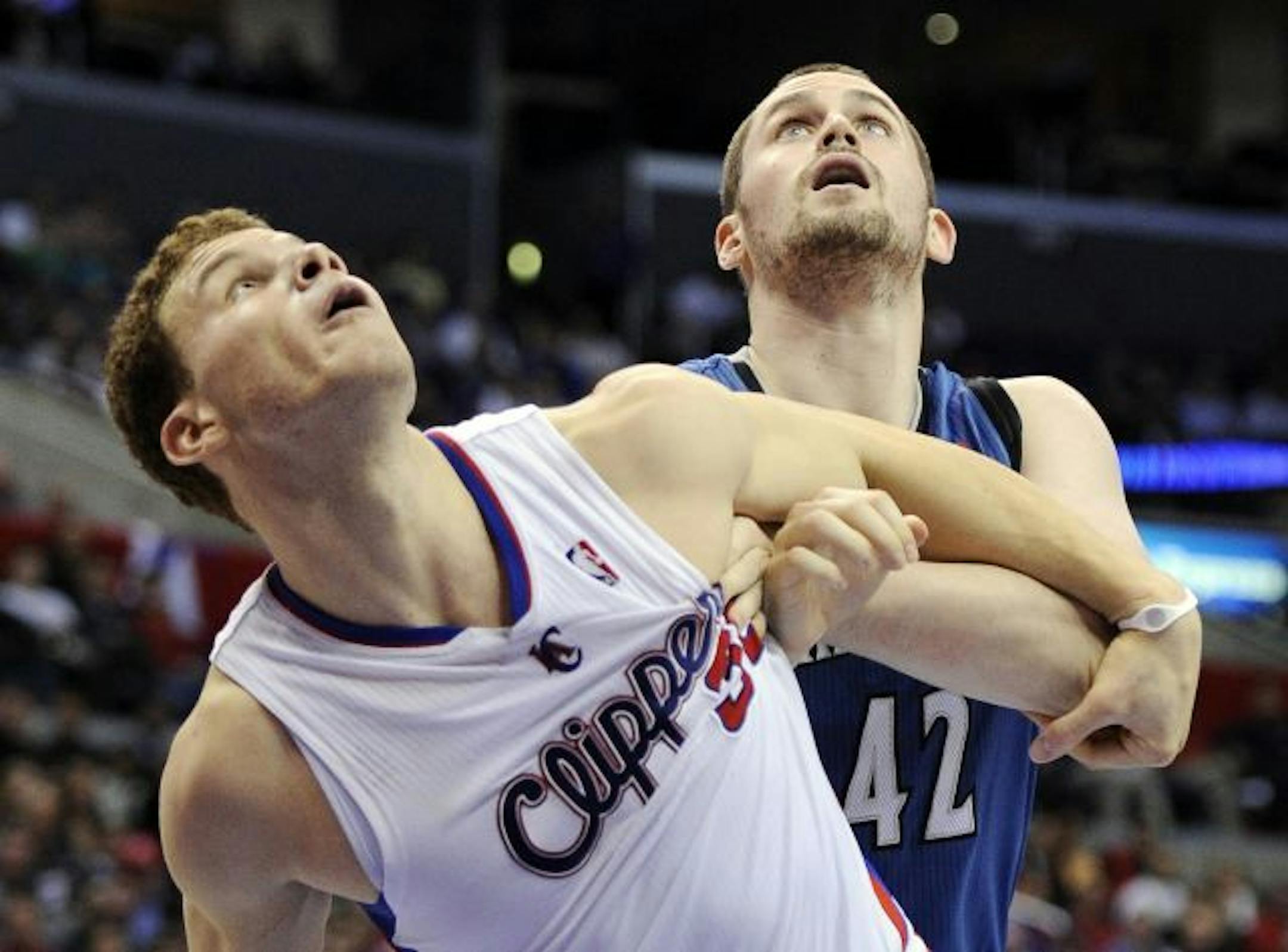 Minnesota Timberwolves forward Kevin Love, right, ties up Los Angeles Clippers forward Blake Griffin as they go after a rebound during the first half of their NBA basketball game, Wednesday, Jan. 19, 2011, in Los Angeles.