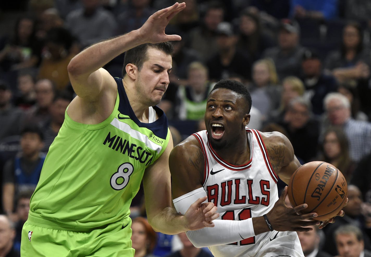 Chicago Bulls' David Nwaba (11) drives against Minnesota Timberwolves' Nemanja Bjelica (8), of Serbia, during the fourth quarter of an NBA basketball game on Saturday, Feb. 24, 2018, in Minneapolis. (AP Photo/Hannah Foslien)