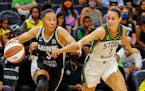 Lynx guard Aerial Powers works past Seattle Storm forward Stephanie Talbot during a game on Aug. 24