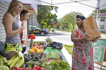 Ivie Flowers, right, chatted with Nicole Herrli, 22, a senior at St. Thomas University, and high school freshman Lunden Woodberry, 14, as she bought a