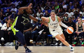 Dallas Wings forward Myisha Hines-Allen (2) guards Minnesota Lynx forward Bridget Carleton (6) in the second half of a WNBA basketball game Friday, Ma