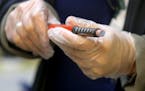 Jolie Holland, a licensed school nurse in the Howard Lake-Waverly-Winstead School District in central Minnesota, prepares an insulin pen for an inject
