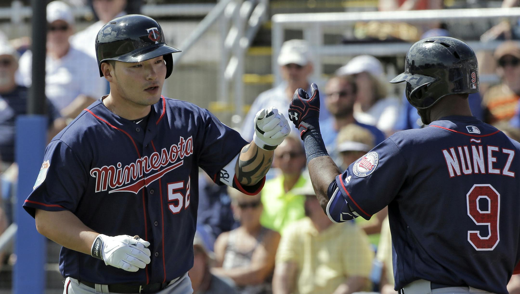Minnesota Twins' Byung Ho Park, left, of South Korea, celebrates with on-deck batter Eduardo Nunez after his home run off Toronto Blue Jays starting pitcher Gavin Floyd during the second inning of a spring training baseball game Tuesday, March 8, 2016, in Dunedin, Fla. (AP Photo/Chris O'Meara)