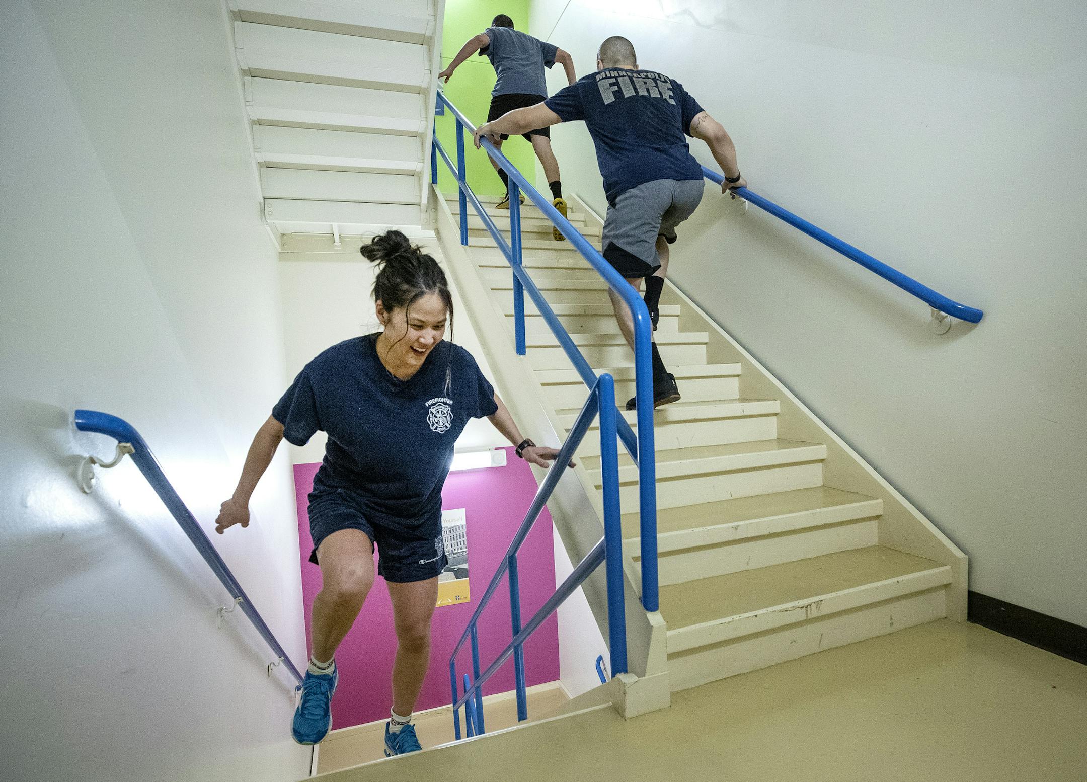 Linda Sone, a driver with the Minneapolis fire department, made her way up the stairs with fellow firefighters during a training session at the Hennepin County Government Center.
