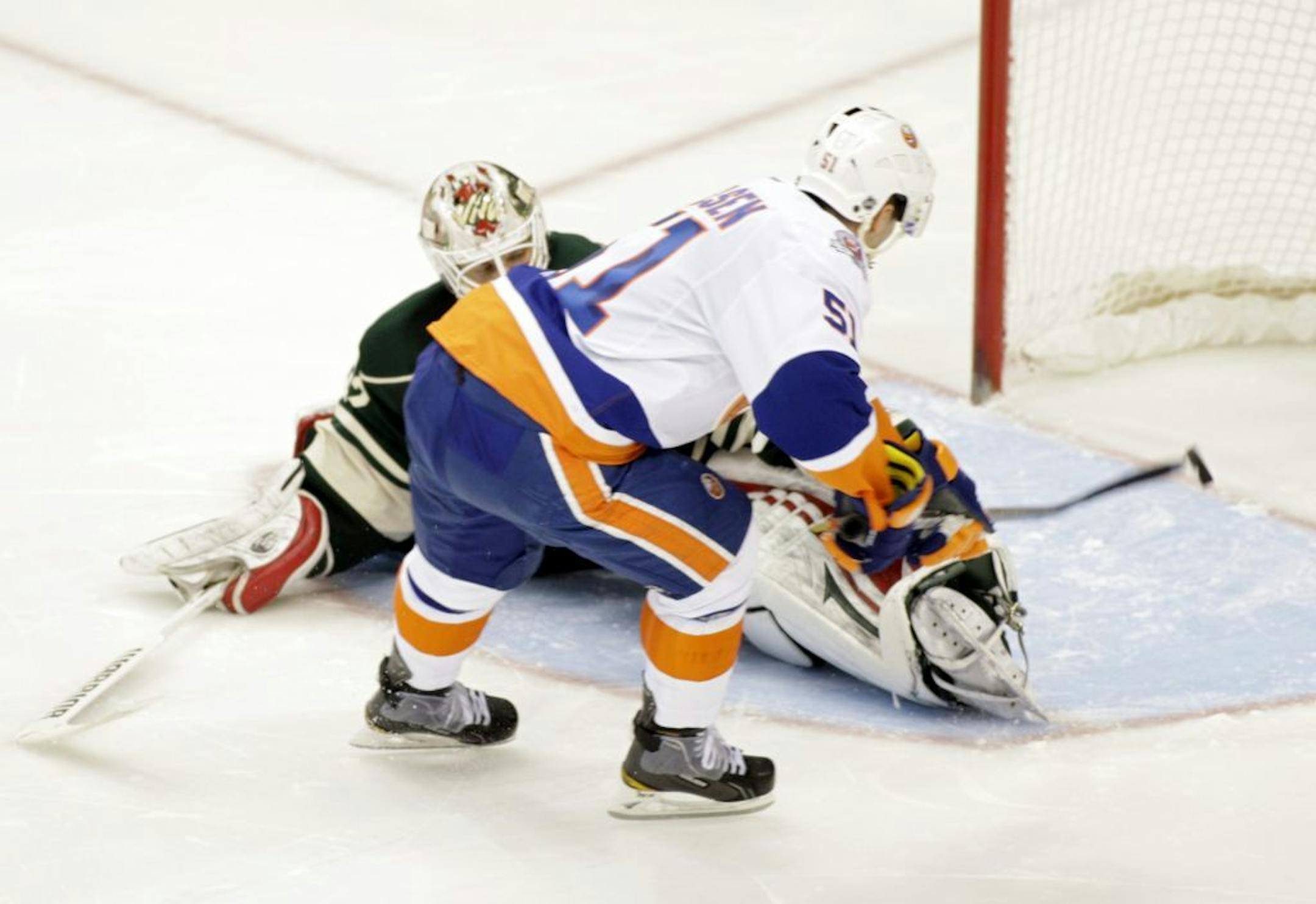 New York Islanders center Frans Nielsen (51), of Denmark, scores the game-winning goal against Minnesota Wild goalie Niklas Backstrom (32), of Finland, during a shootout in an NHL hockey game, Saturday, Dec. 17, 2011, in St. Paul, Minn. The Islanders won 2-1.