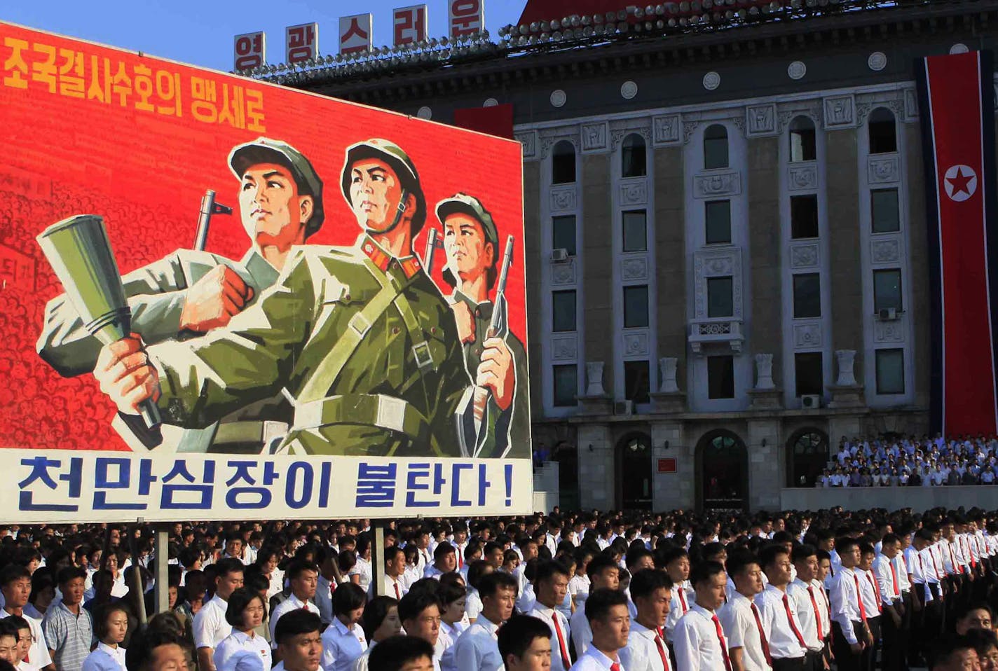 Tens of thousands of North Koreans gathered for a rally at Kim Il Sung Square carrying placards and propaganda slogans as a show of support for their rejection of the United Nations' latest round of sanctions on Wednesday Aug. 9, 2017, in Pyongyang, North Korea. (AP Photo/Jon Chol Jin)