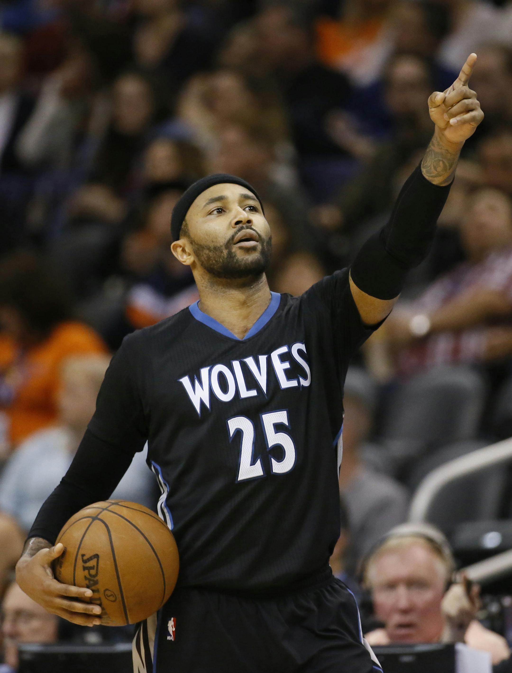 Minnesota Timberwolves' Mo Williams points to the video board after a foul call during the second half of an NBA basketball game against the Phoenix Suns, Friday, Jan. 16, 2015, in Phoenix. (AP Photo/Matt York)