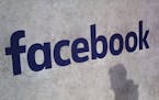 File - This Jan. 17, 2017, file photo shows a Facebook logo being displayed in a start-up companies gathering at Paris' Station F, in Paris.