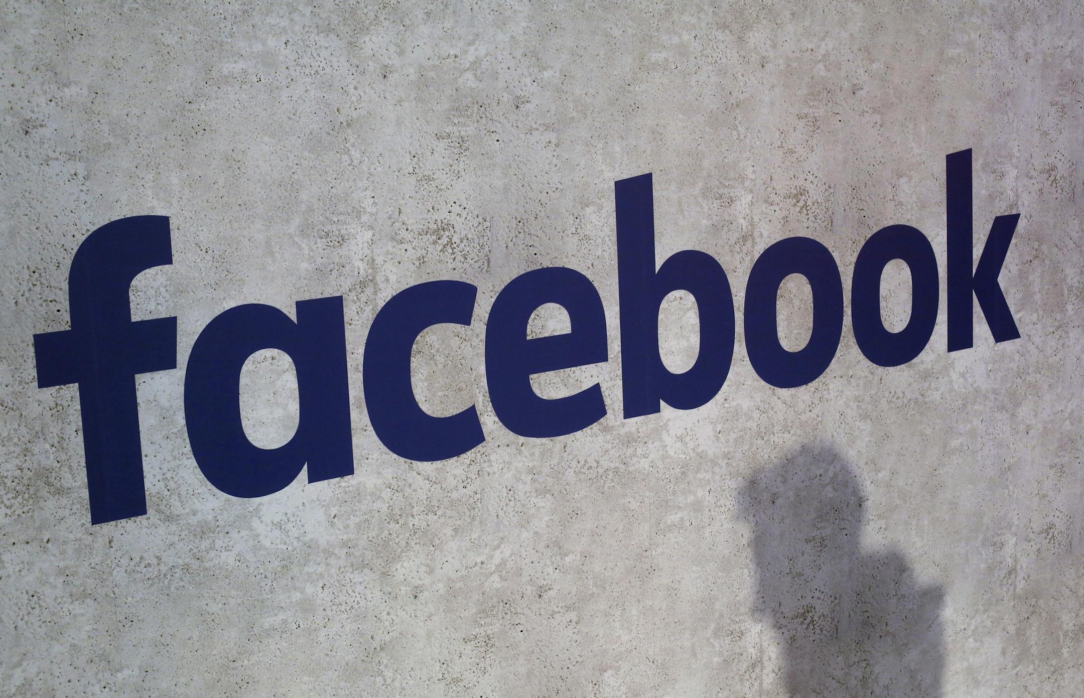File - This Jan. 17, 2017, file photo shows a Facebook logo being displayed in a start-up companies gathering at Paris' Station F, in Paris.
