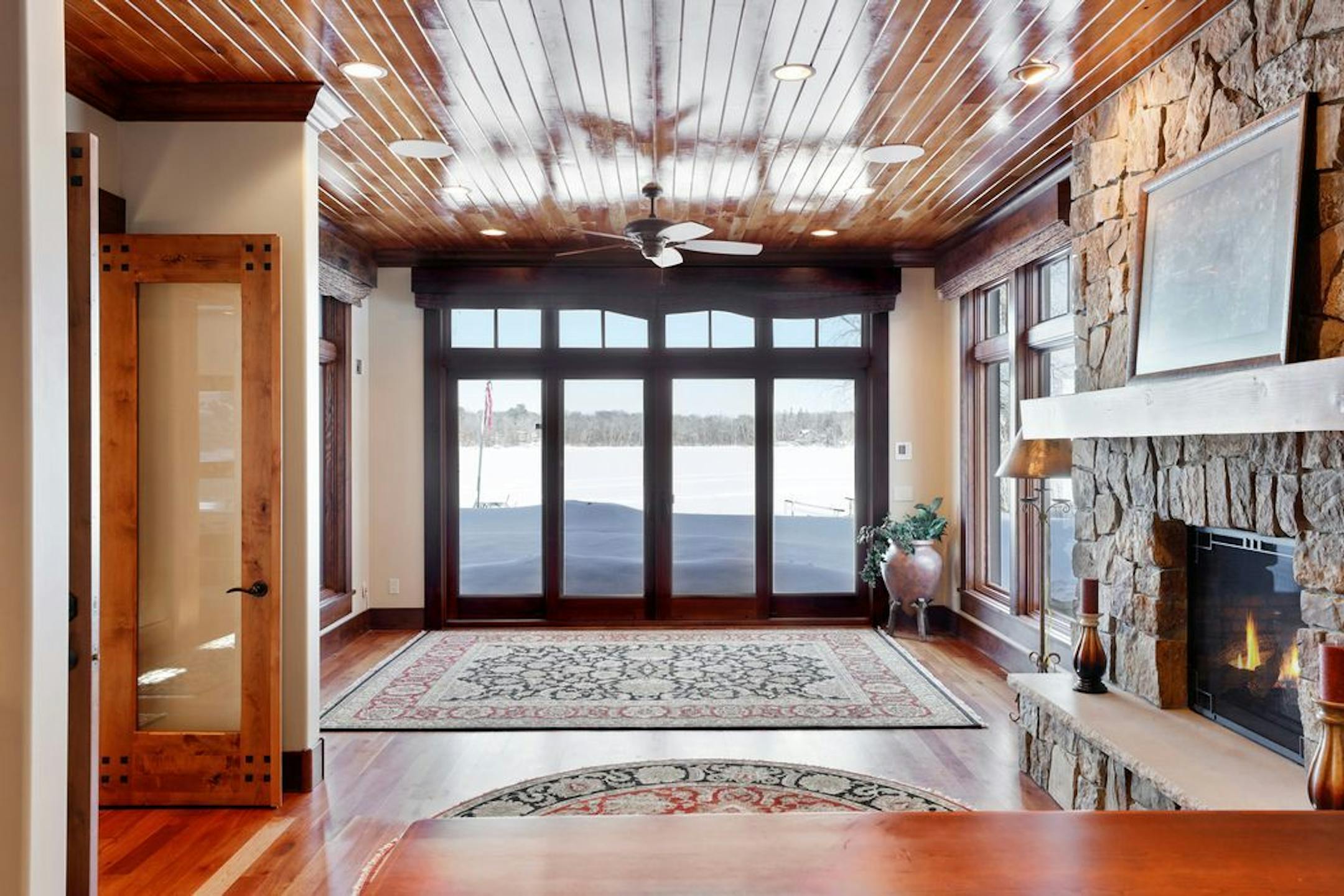 Another room with a fireplace and lake view.
