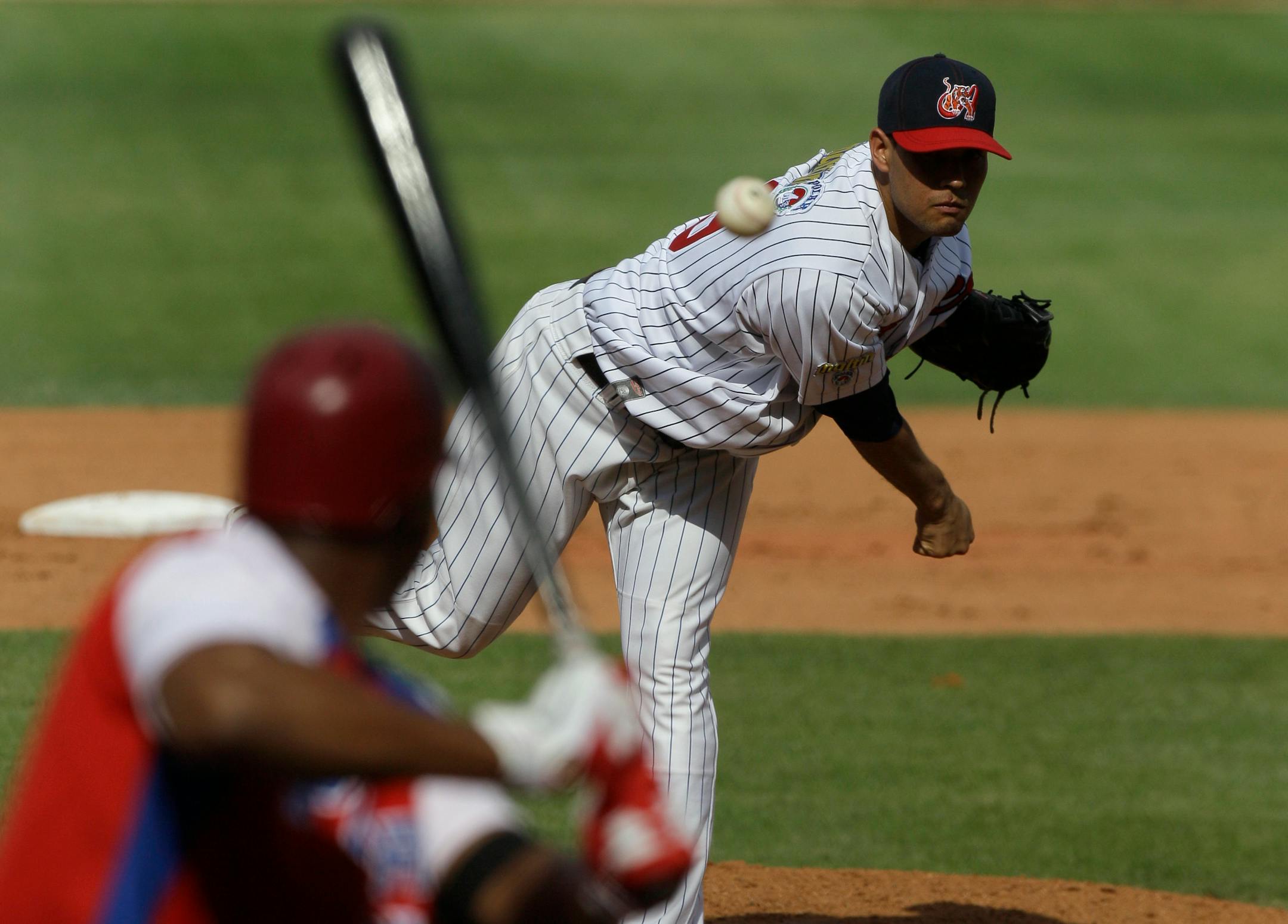Venezuela's pitcher starting Yohan Pino, right, throws in the first inning during a Caribbean Series baseball game against Puerto Rico at Quisqueya stadium in Santo Domingo, Dominican Republic, Sunday, Feb. 5, 2012. (AP Photo/Fernando Llano)