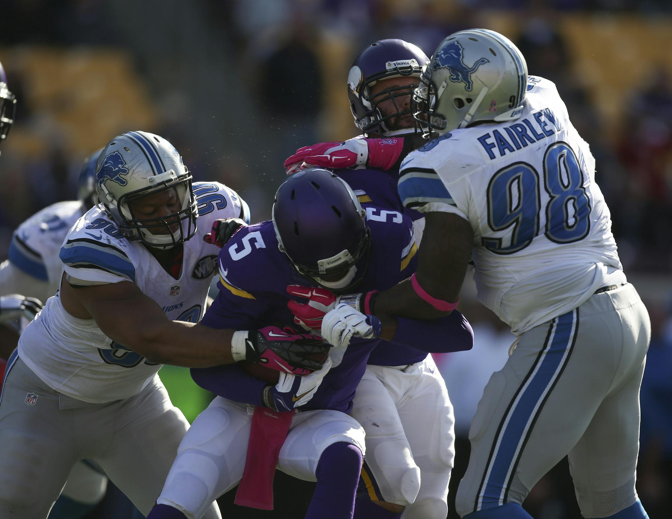 Minnesota Vikings quarterback Teddy Bridgewater (5) was sacked for a two yard loss by Detroit Lions defensive tackle Ndamukong Suh (90) late in the fourth quarter Sunday afternoon. Detroit Lions defensive tackle Nick Fairley (98) also had a hand in on the play.