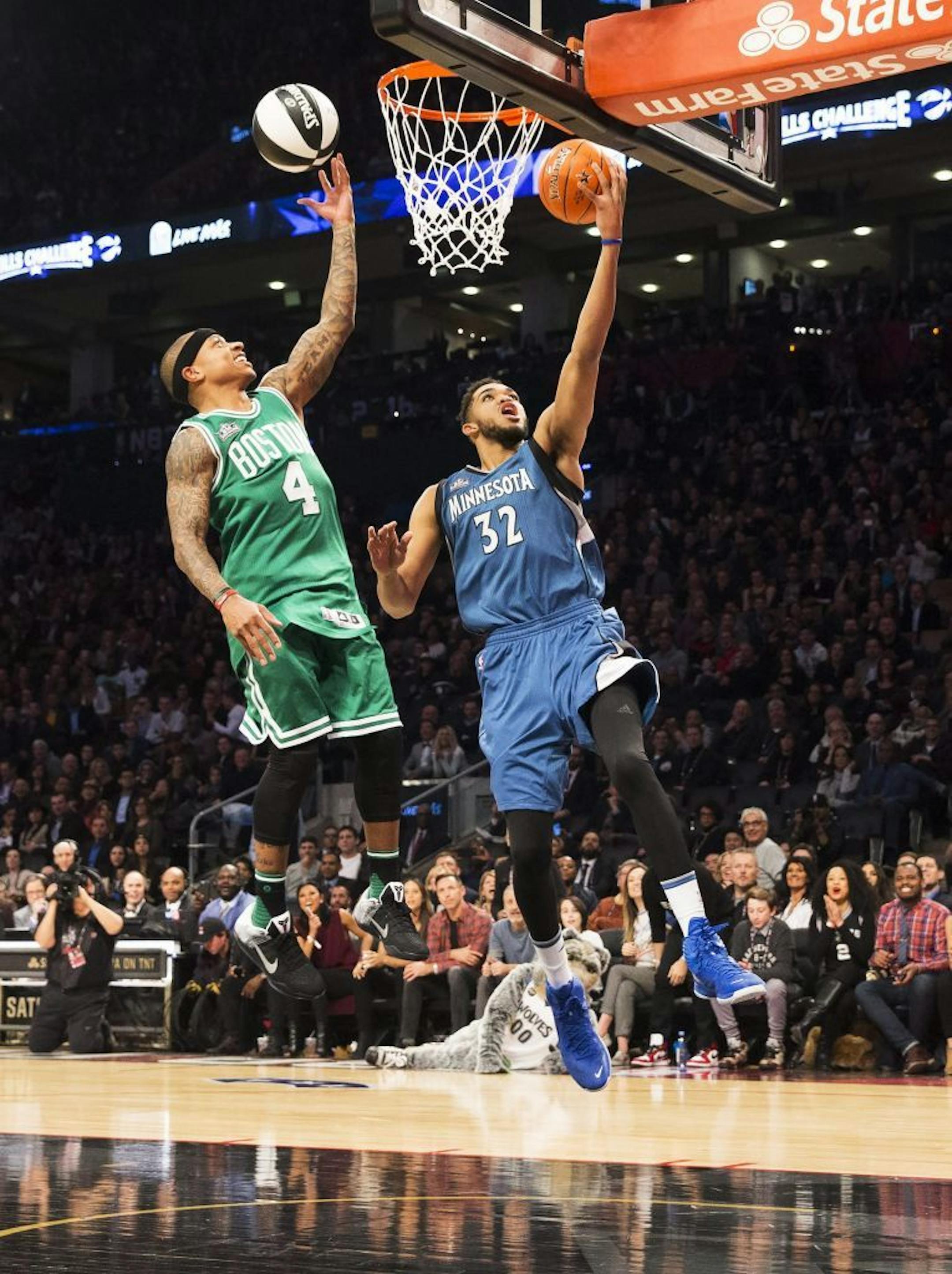 Minnesota Timberwolves' Karl-Anthony Towns (32) and Boston Celtics' Isaiah Thomas compete during the NBA all-star skills competition in Toronto on Saturday, Feb. 13, 2016. (Mark Blinch/The Canadian Press via AP) MANDATORY CREDIT