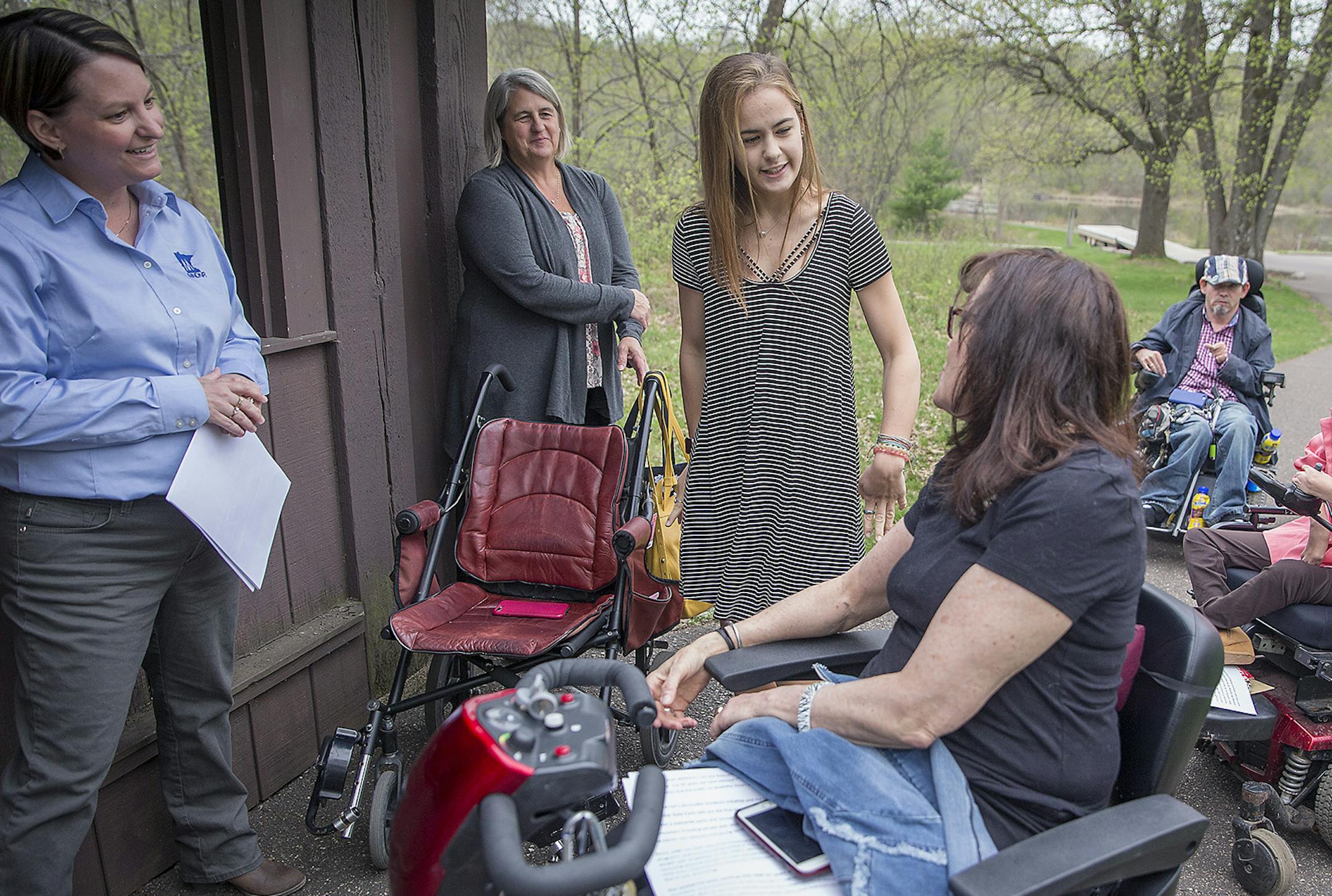 Katie Alee, 16-year-old wheelchair user and accessibility advocate, center, met with other state representatives and advocates at the William O'Brien State Park for a press conference where she spoke for accessibility improvements needed at the park and other statewide parks, Tuesday, May 8, 2018 at Marine on St. Croix, MN. Governor Mark Dayton has submitted a $10 million bonding request for accessibility improvements at Minnesota state parks. ] ELIZABETH FLORES &#xef; liz.flores@startribune.com
