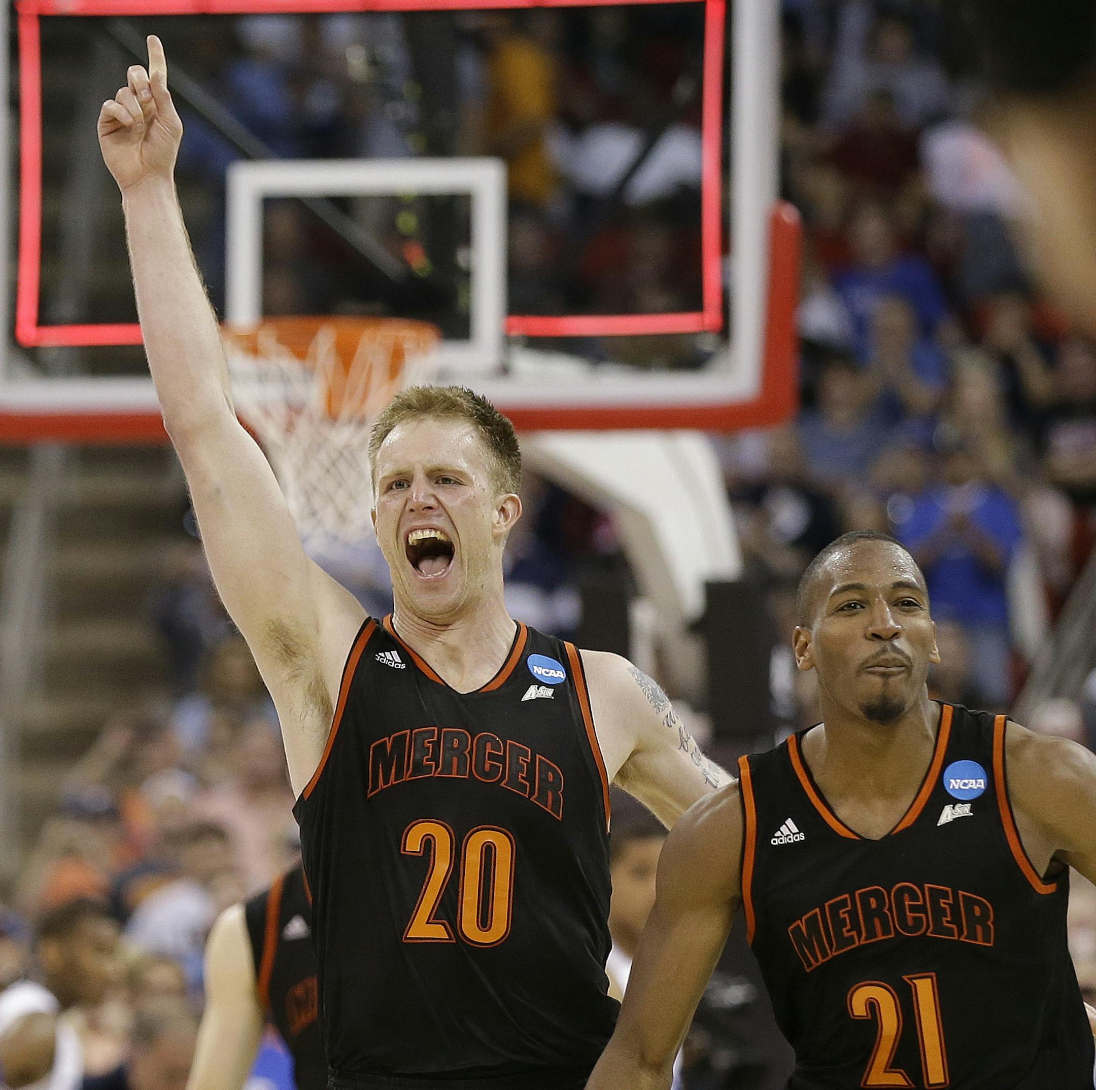 Mercer forward Jakob Gollon (20) and guard Langston Hall (21) celebrate after defeating Duke 78-71 in an NCAA college basketball second-round game against Duke, Friday, March 21, 2014, in Raleigh, N.C.(AP Photo/Gerry Broome)