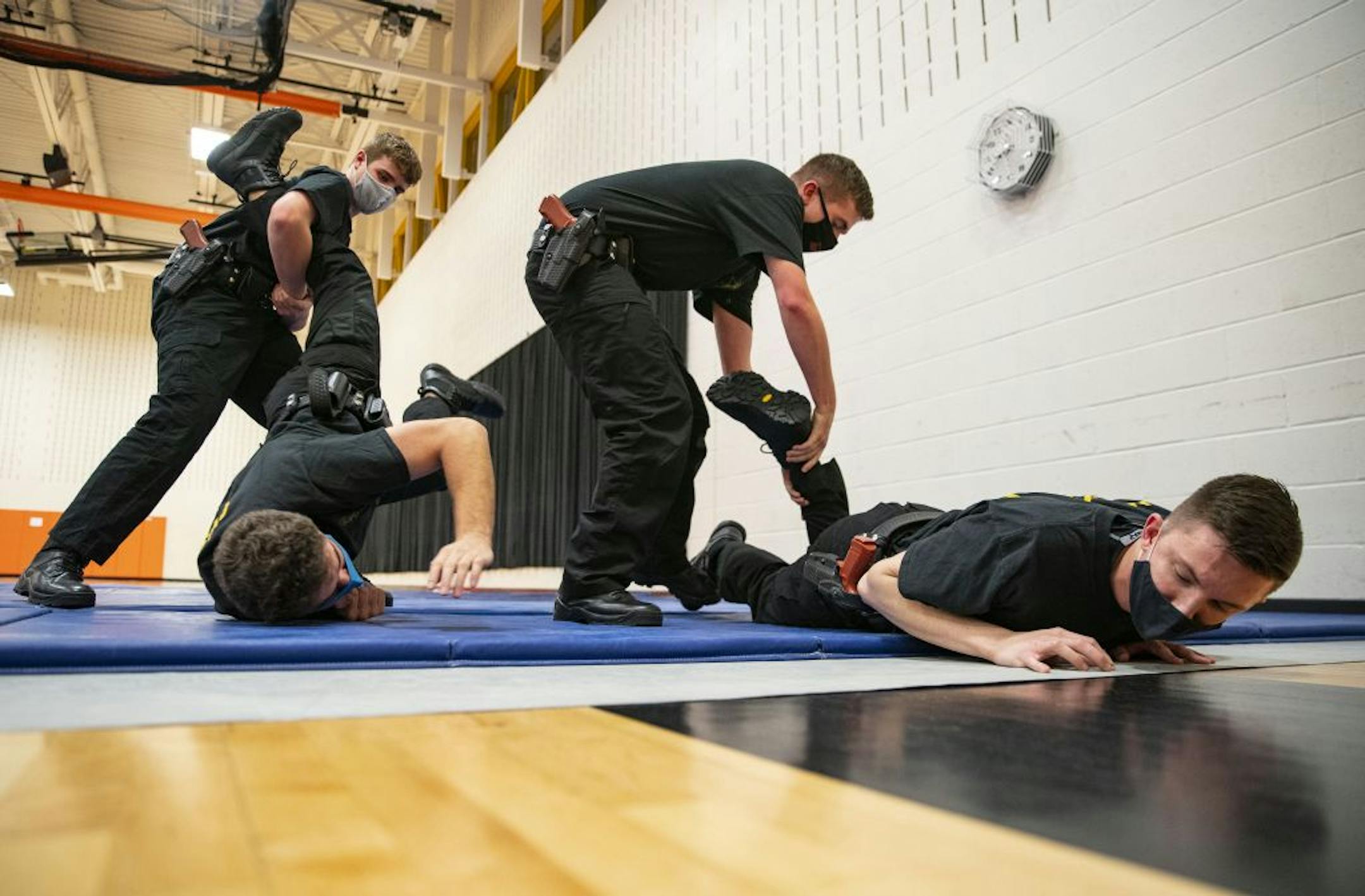 (From Left) Lucas Pyrlik, Dylan Crist, Collin O'Toole and Zachary Haldorson practiced proper ground fighting technique during defensive tactics class at Fond Du Lac Tribal and Community College in Cloquet, Minn. on Tuesday November 17, 2020.